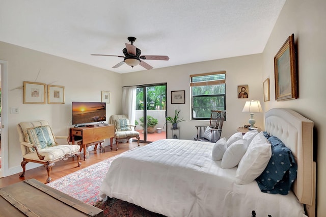 bedroom featuring ceiling fan, access to outside, and hardwood / wood-style floors