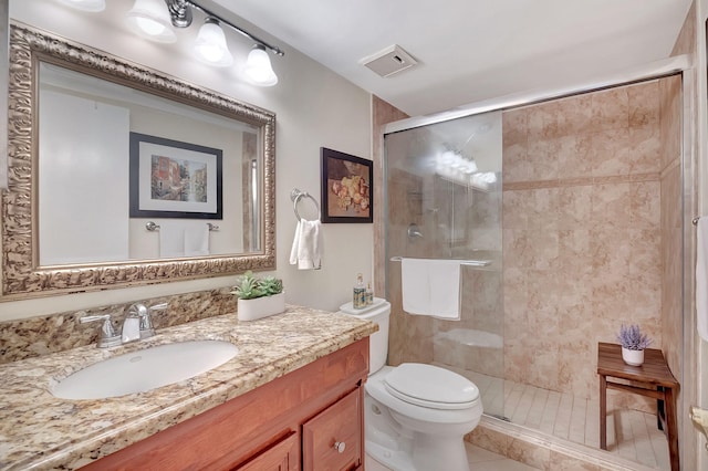 bathroom featuring vanity, toilet, tile patterned flooring, and an enclosed shower