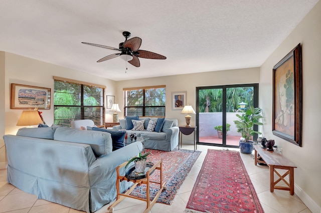 tiled living room with a textured ceiling and ceiling fan