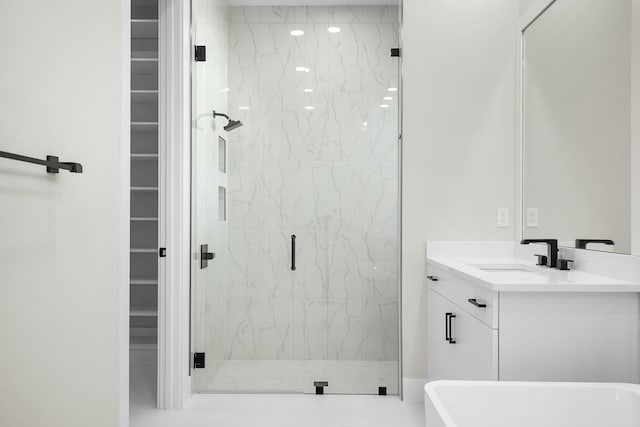 bathroom featuring vanity and an enclosed shower