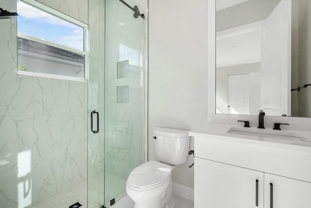 bathroom with an enclosed shower, vanity, and toilet