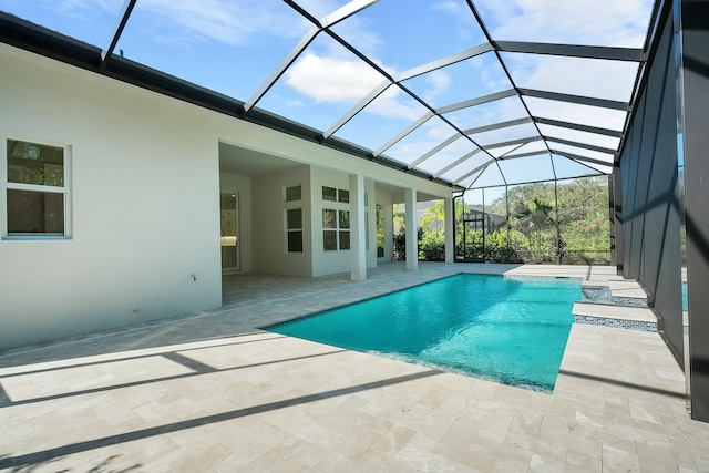 view of swimming pool featuring a lanai and a patio