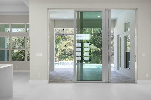 doorway with light tile patterned floors