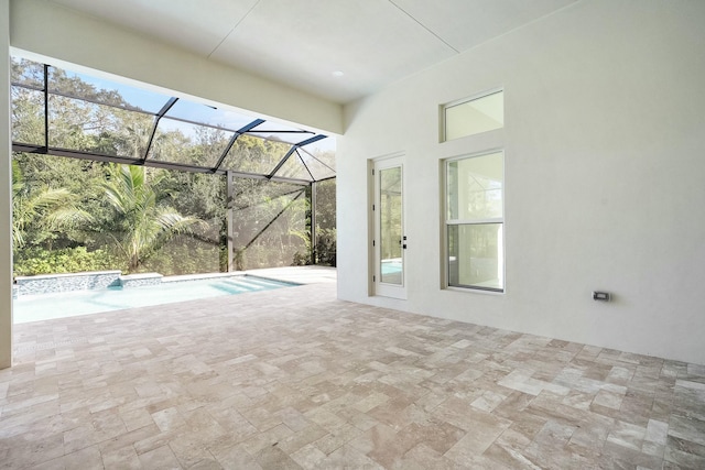 view of swimming pool featuring a lanai and a patio area