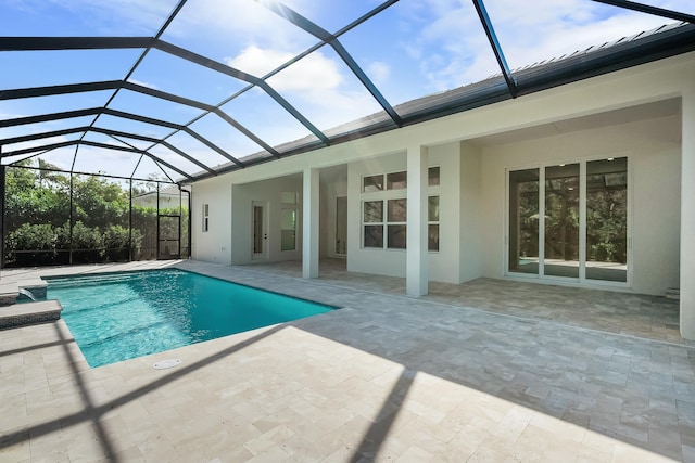 view of pool featuring a patio area and glass enclosure