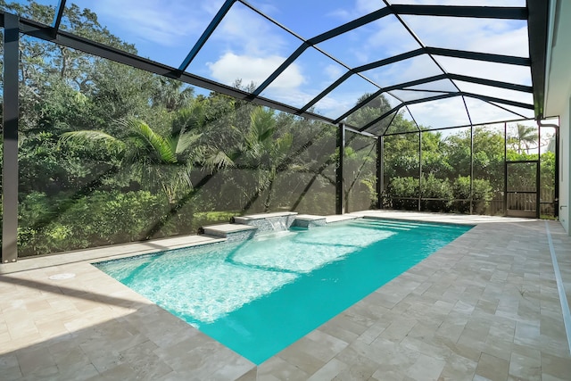 view of swimming pool featuring pool water feature, a patio, and glass enclosure