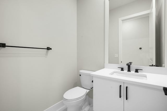 bathroom featuring toilet and vanity