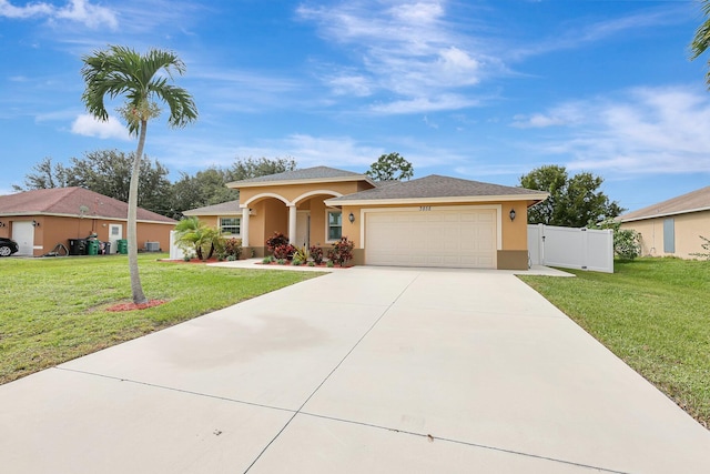 view of front of house with a front yard and a garage