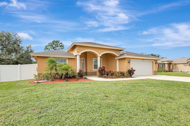 view of front of house featuring a front yard and a garage