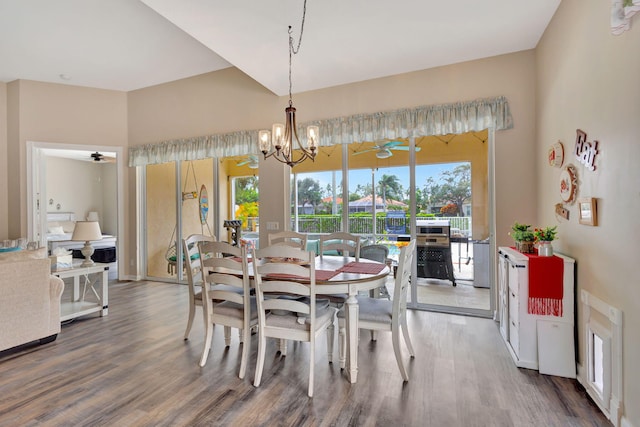 dining room featuring wood-type flooring and ceiling fan with notable chandelier