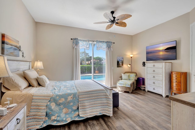 bedroom featuring wood finished floors, access to outside, and ceiling fan