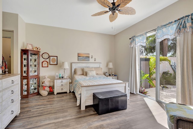 bedroom featuring ceiling fan, access to exterior, and dark hardwood / wood-style floors