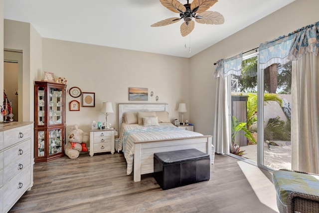 bedroom with access to outside, wood finished floors, and ceiling fan