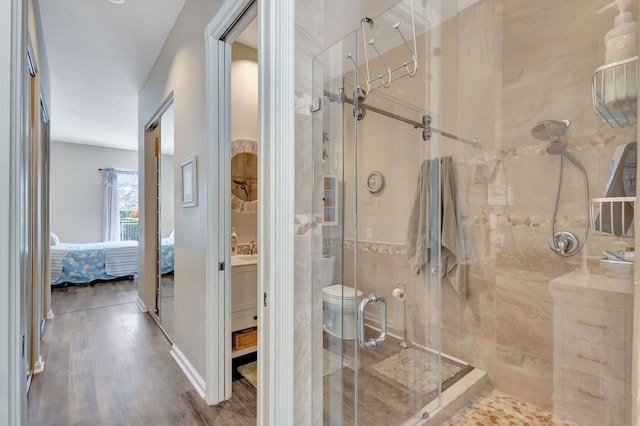 bathroom featuring walk in shower, tile walls, and hardwood / wood-style flooring