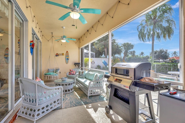 sunroom / solarium with ceiling fan and an outdoor living space
