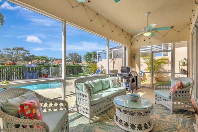 sunroom / solarium featuring ceiling fan