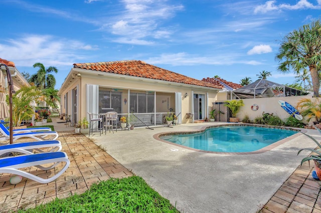 view of swimming pool featuring a lanai and a patio