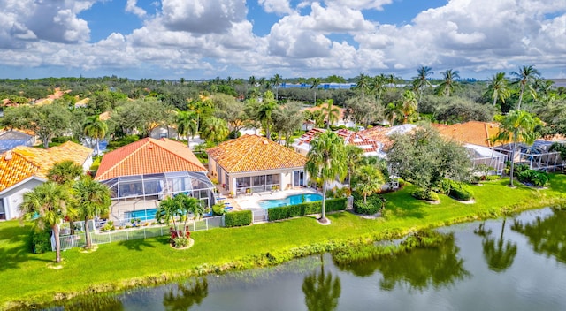 aerial view of residential area with a pool and a large body of water