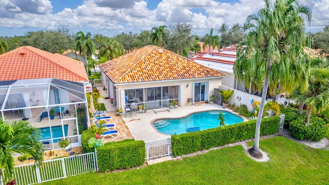 view of swimming pool featuring a patio, a gate, and glass enclosure