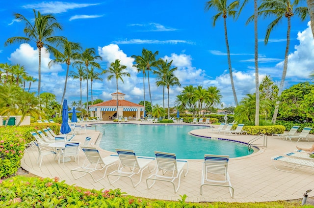 community pool with a patio and a gazebo