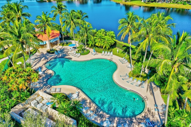 view of pool with a patio and a water view