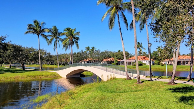 surrounding community with a yard and a water view