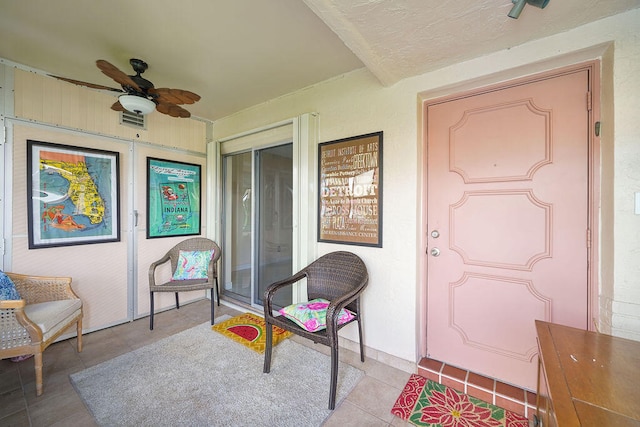 interior space featuring ceiling fan