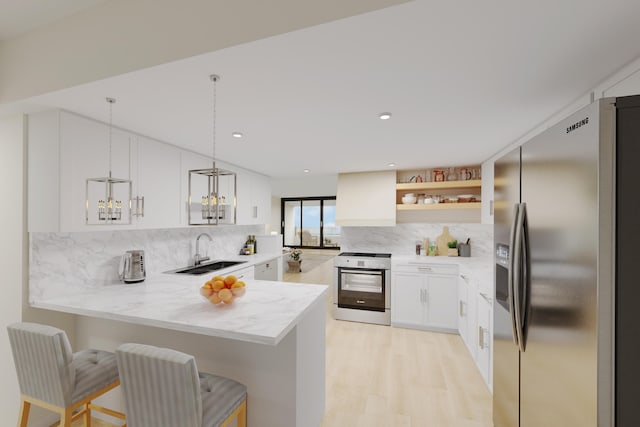 kitchen featuring kitchen peninsula, stainless steel appliances, sink, and pendant lighting