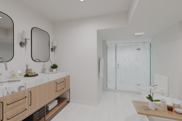 bathroom featuring a shower with door and vanity