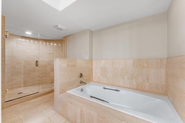 bathroom featuring tile patterned flooring and separate shower and tub