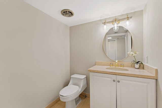 bathroom with vanity, toilet, and tile patterned floors