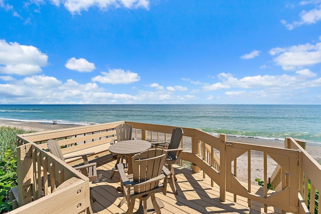 deck with a water view and a view of the beach