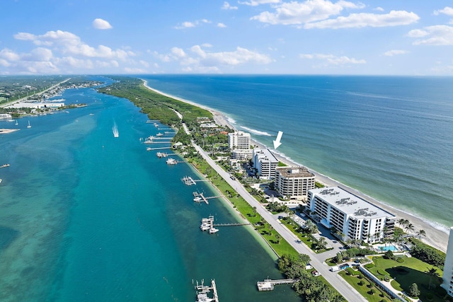 drone / aerial view with a water view and a beach view