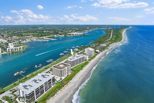 bird's eye view featuring a water view and a beach view