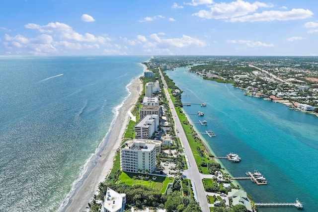 aerial view with a water view and a beach view