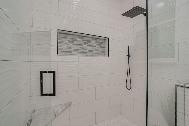 bathroom with a shower with door