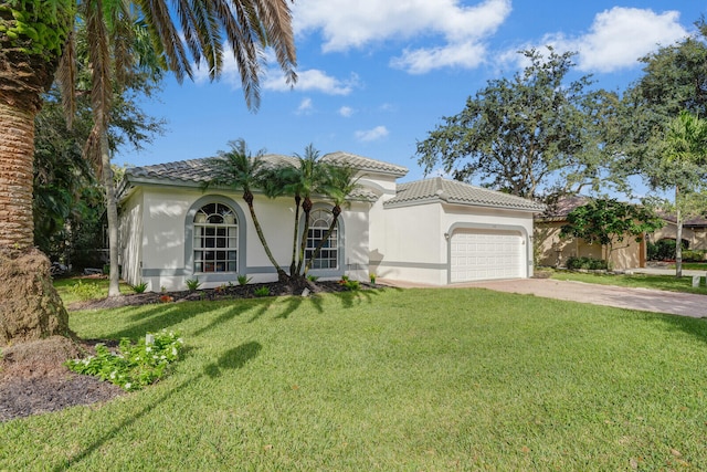 mediterranean / spanish house with a front yard and a garage