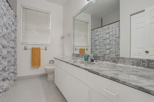 bathroom with vanity, a shower with curtain, toilet, and tile patterned flooring