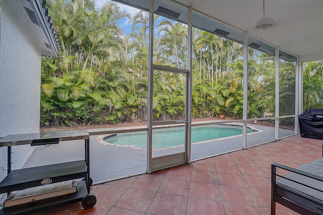 view of swimming pool with area for grilling, a patio area, and ceiling fan