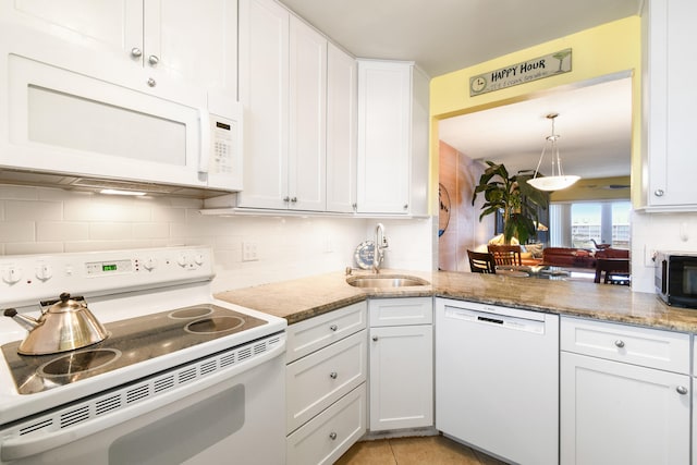 kitchen with decorative backsplash, white cabinetry, sink, and white appliances