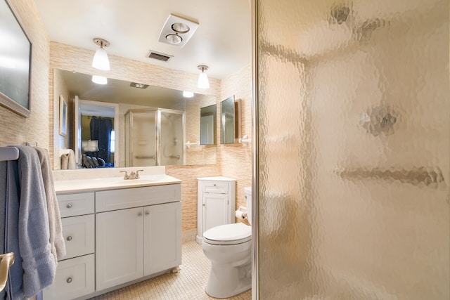 bathroom with vanity, tile patterned floors, toilet, and an enclosed shower