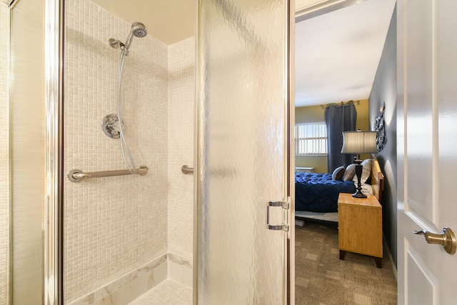 bathroom featuring a shower with shower door