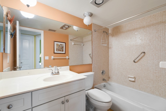 full bathroom featuring tiled shower / bath, vanity, and toilet