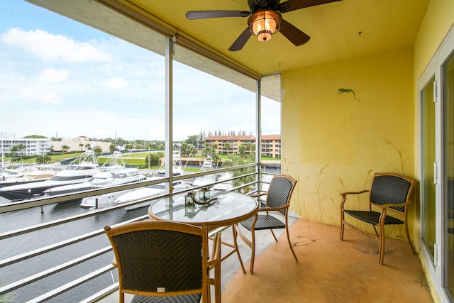 balcony with a water view and ceiling fan