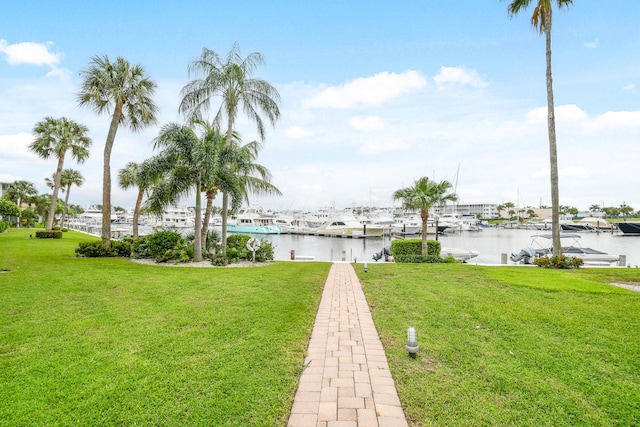 view of dock featuring a water view and a lawn