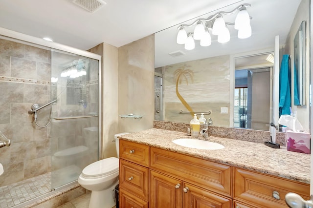 bathroom with vanity, toilet, and a shower with door