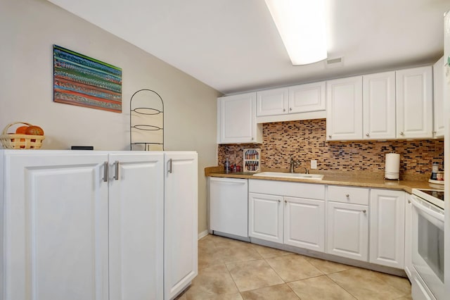 kitchen with sink, white cabinets, white appliances, and tasteful backsplash