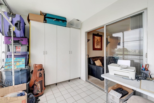 home office featuring a wall mounted AC and light tile patterned floors