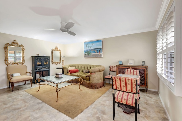 living room with crown molding, light tile patterned floors, and ceiling fan