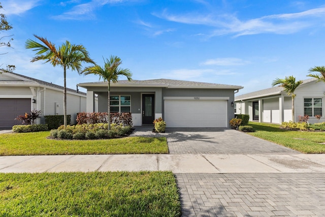 ranch-style home with a garage and a front yard